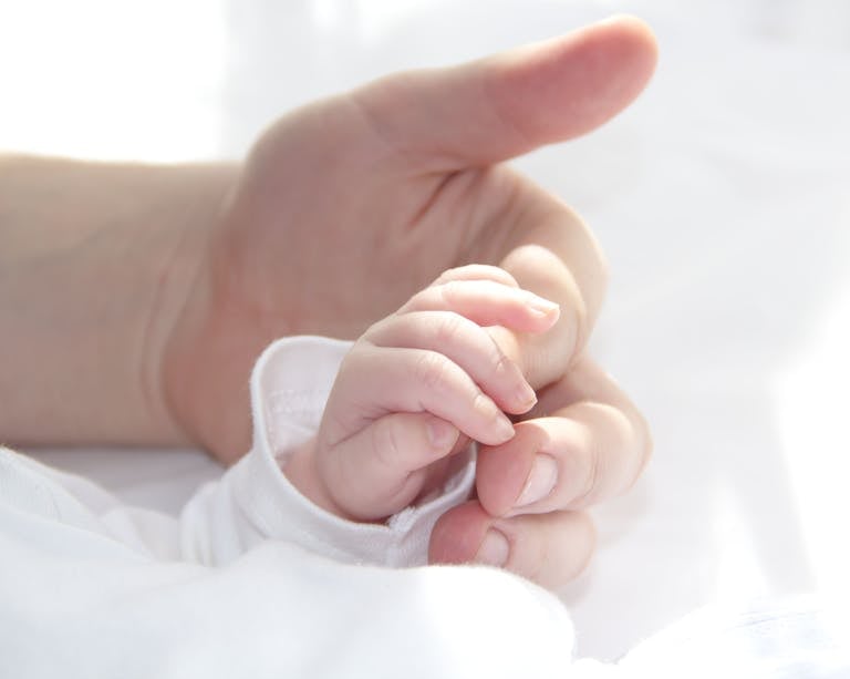 Hands of father and baby